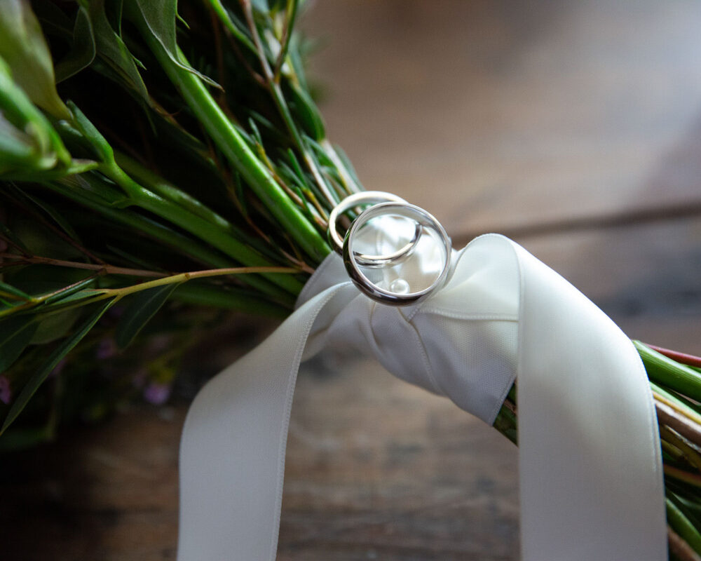 Leeds wedding photography - The wedding rings placed on a bouquet ribbon